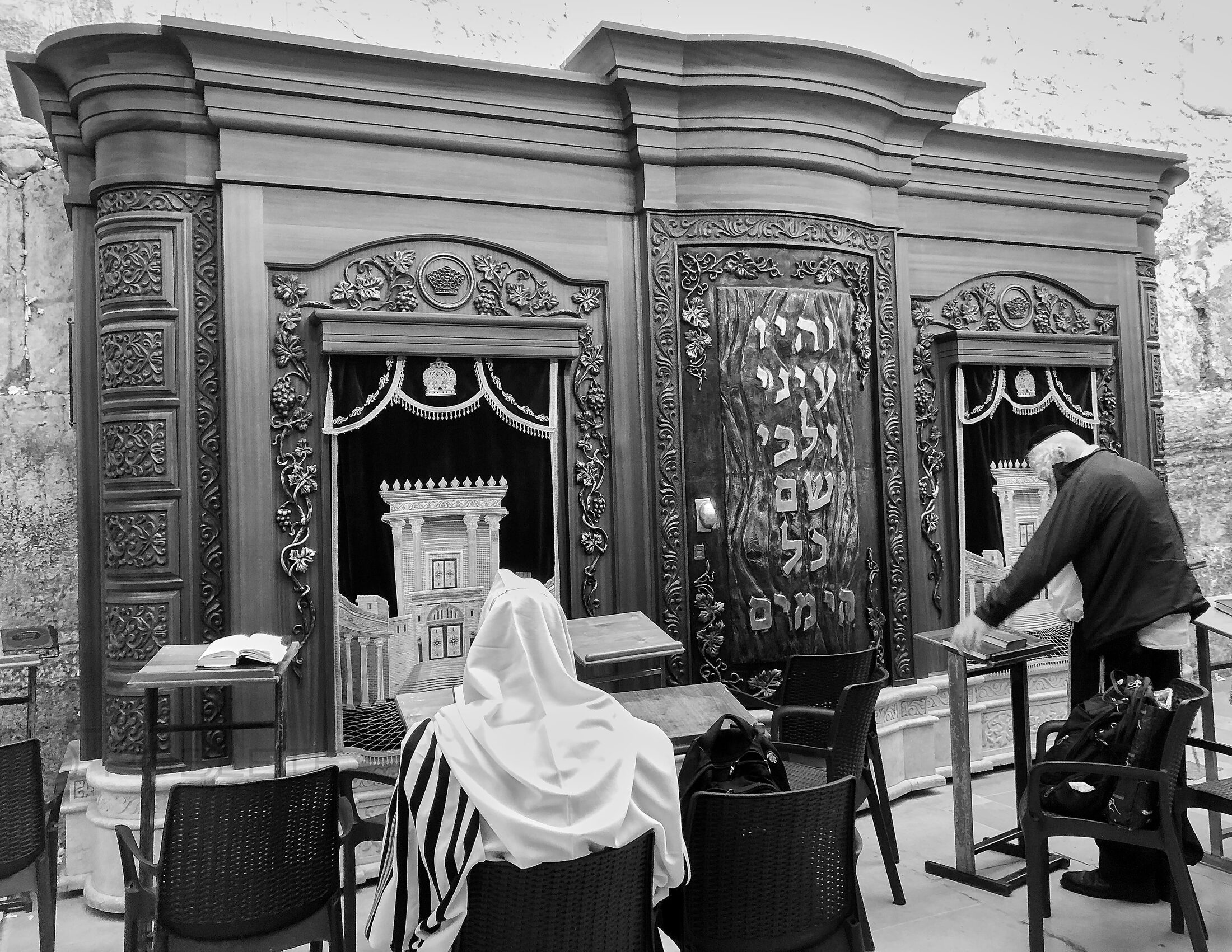 A person stands at the entrance of an ornate religious building.