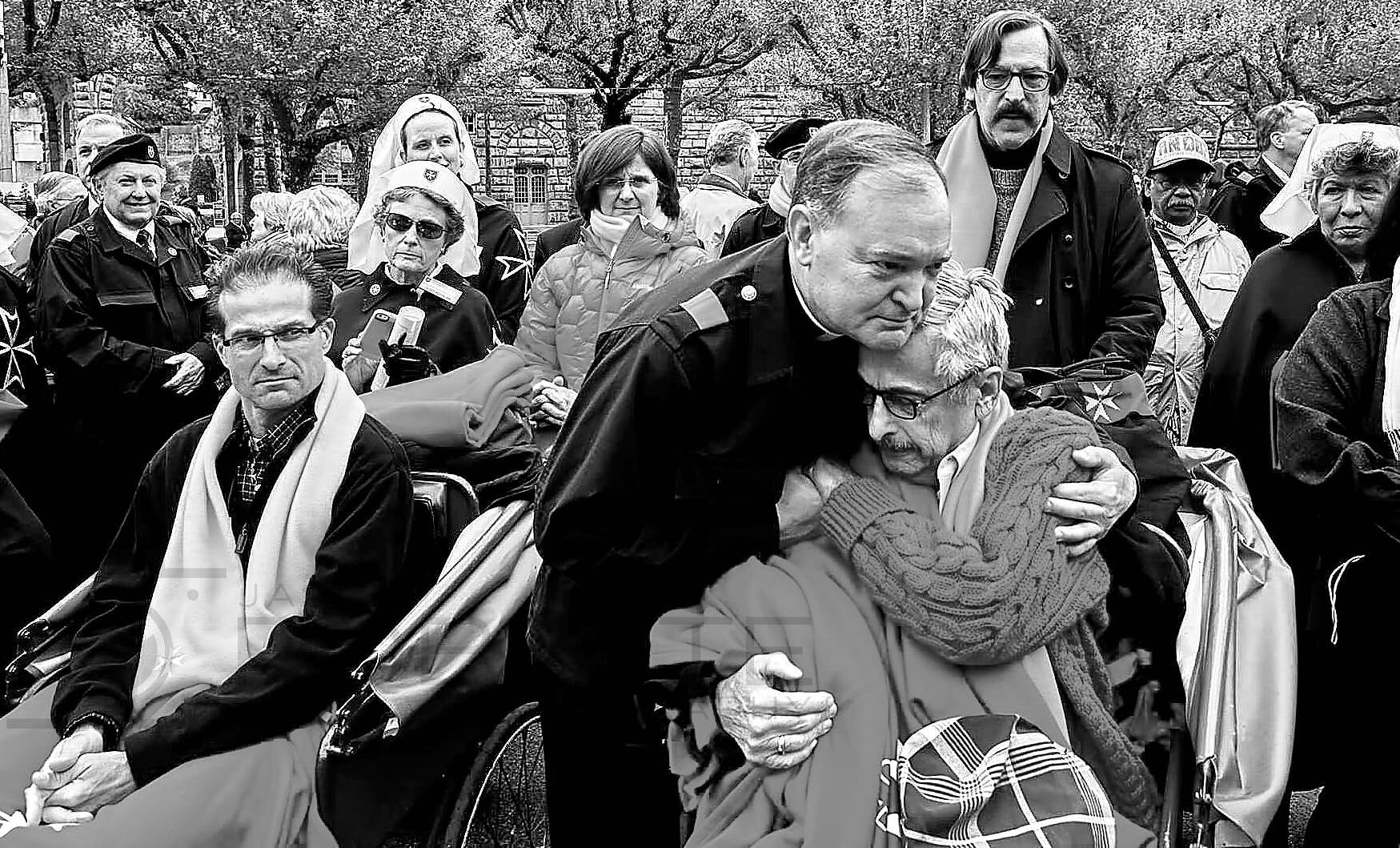 Clergy and onlookers gather closely during a public ceremony.