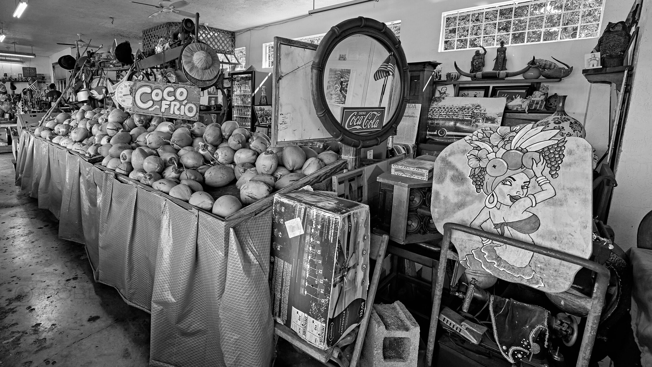 Handmade goods and small merchandise crowd a market table.
