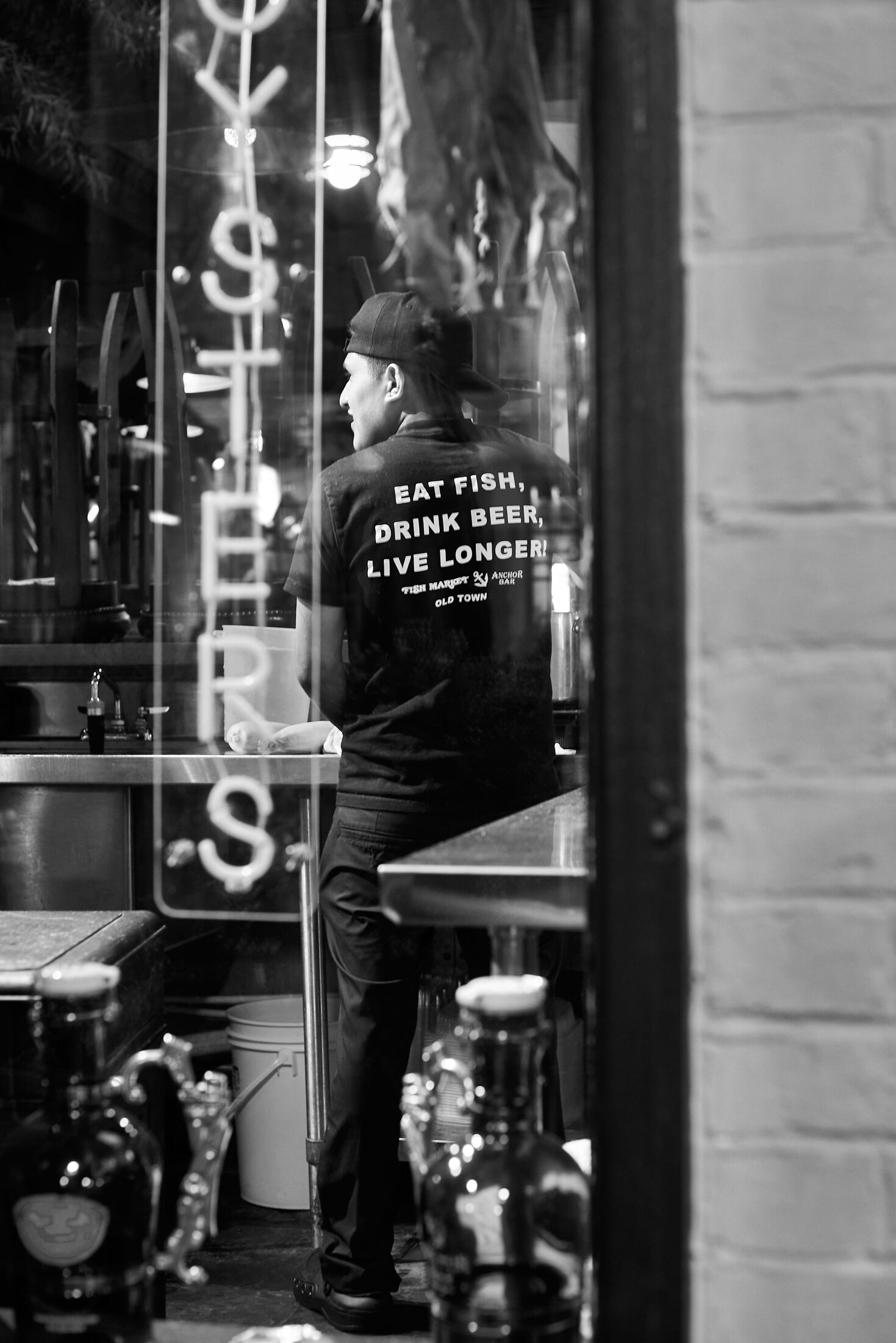 A person stands in the narrow entrance of an oyster bar.