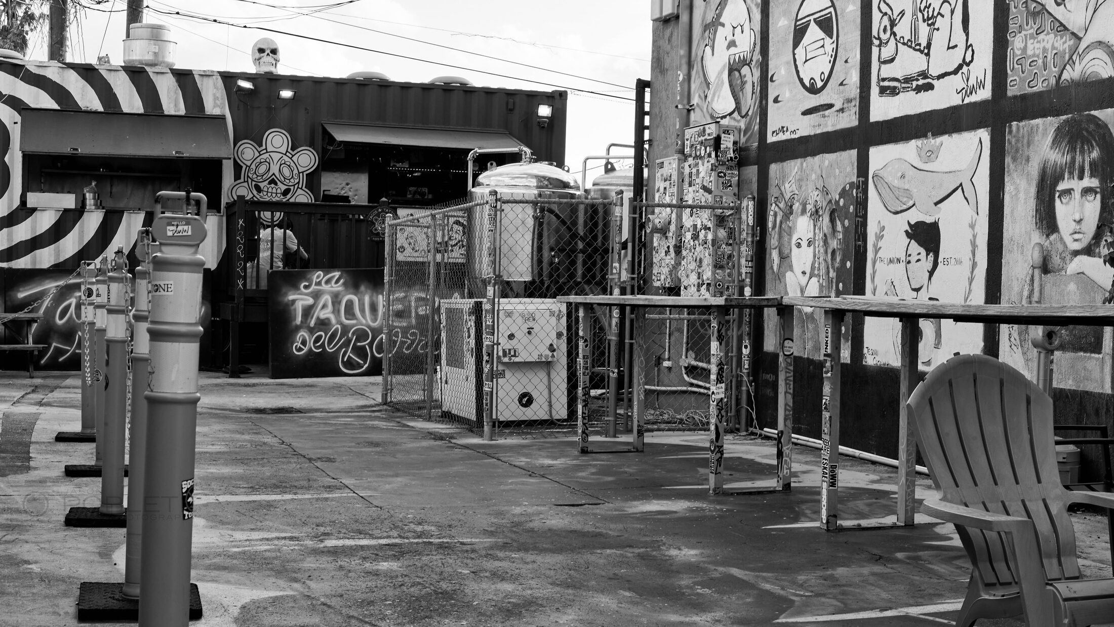 Crates and supplies are stacked outside a closed market stall.