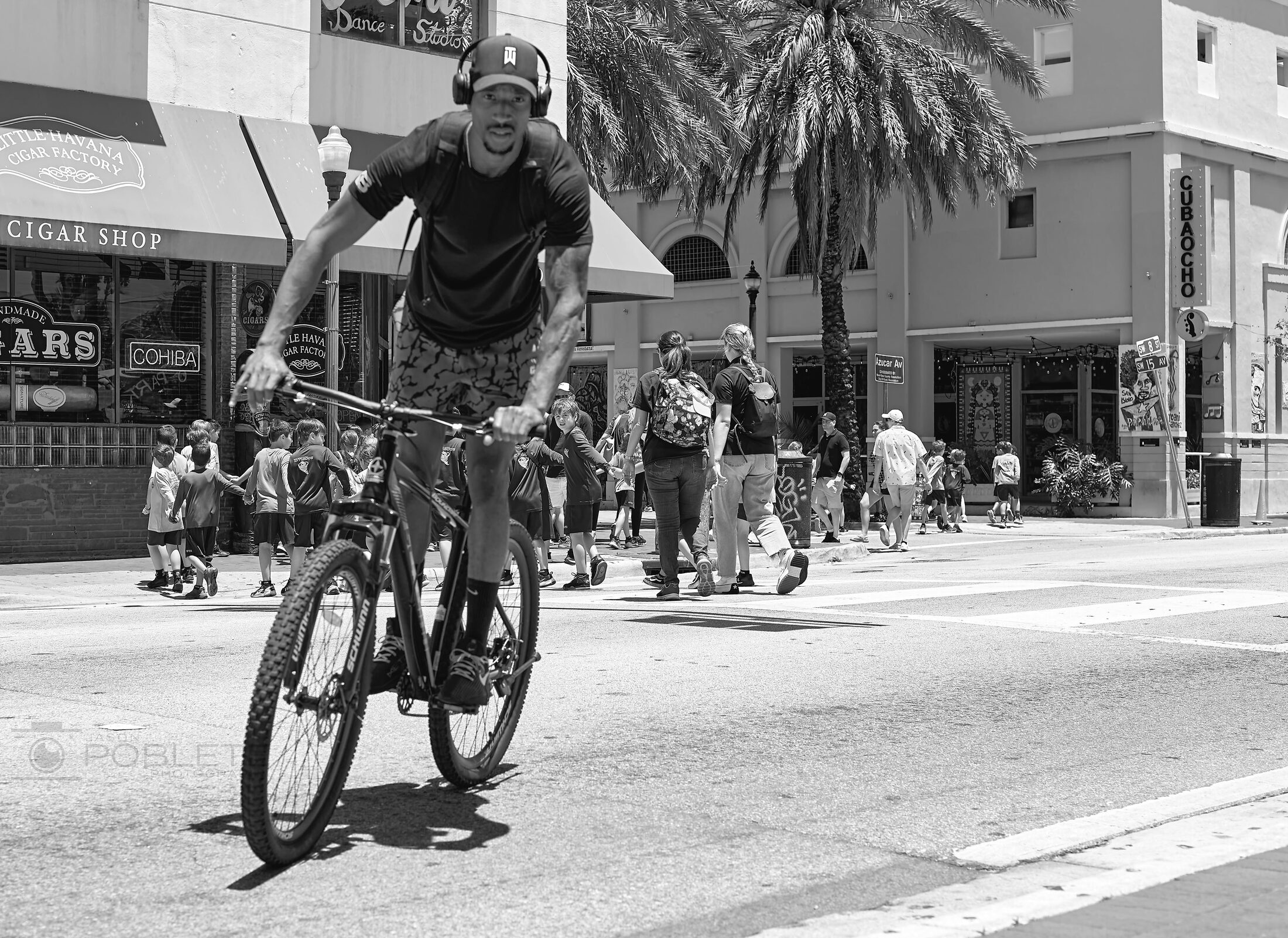 A cyclist rides through an urban intersection.