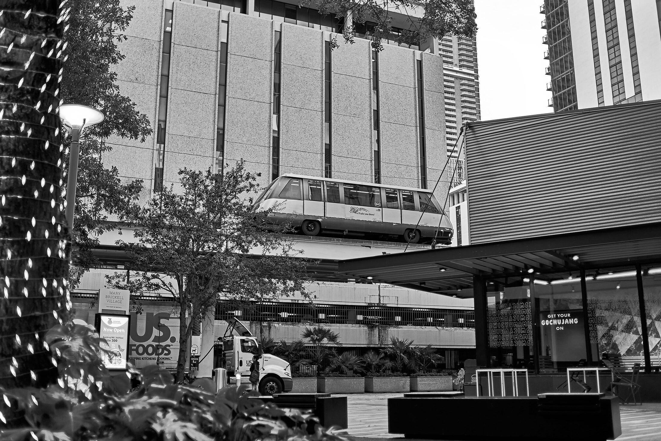 Elevated rail structures cut across a dense cluster of city buildings.
