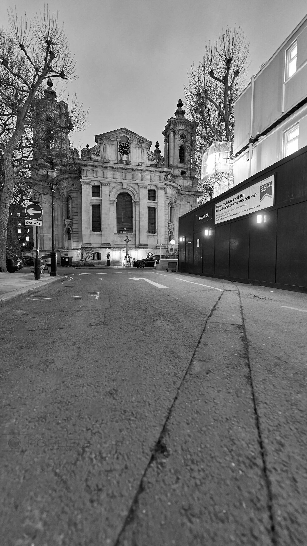A tilted sidewalk view leads toward a church façade.