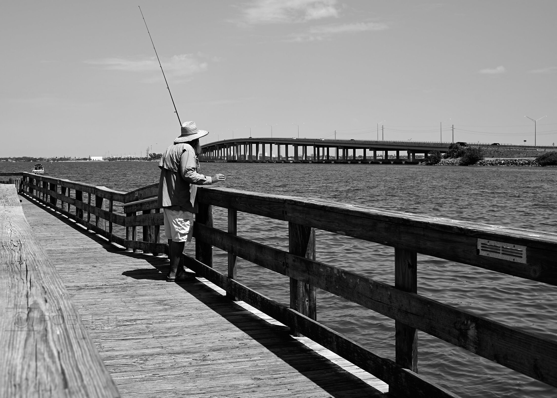 A solitary fisherman stands near the end of Melbourne Pier.